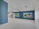 Open living area with built-in shelving and large windows with picturesque views of the well-maintained yard at 3702 N 160Th Ave, Goodyear, AZ 85395