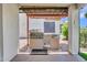 Outdoor kitchen with grill and countertop under a pergola-style covering at 3702 N 160Th Ave, Goodyear, AZ 85395