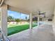 Covered patio with ceiling fans offers outdoor seating and shade with view of manicured yard at 3702 N 160Th Ave, Goodyear, AZ 85395