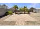 Private backyard with desert landscaping, tall block fence and pavers for easy care at 37711 W Bello Ln, Maricopa, AZ 85138