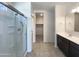 Bathroom featuring a glass shower and large vanity with dark cabinets at 37711 W Bello Ln, Maricopa, AZ 85138