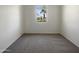 Bedroom with carpet and a view of palm trees through the window at 37711 W Bello Ln, Maricopa, AZ 85138