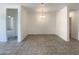 An empty dining room featuring tiled floors and neutral paint at 37711 W Bello Ln, Maricopa, AZ 85138