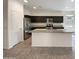 Open kitchen featuring granite countertops, stainless steel appliances, and a large island at 37711 W Bello Ln, Maricopa, AZ 85138