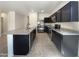 The kitchen features stainless appliances, dark cabinets, and an island with granite countertops at 37711 W Bello Ln, Maricopa, AZ 85138
