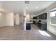 Bright kitchen with stainless appliances, dark cabinets, and a kitchen island at 37711 W Bello Ln, Maricopa, AZ 85138