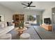 Bright living room with tile flooring, neutral decor, and sliding doors to the back patio at 37711 W Bello Ln, Maricopa, AZ 85138