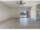 The living room has tile floors, a ceiling fan, and sliding glass doors to the patio at 37711 W Bello Ln, Maricopa, AZ 85138