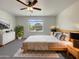 Comfortable bedroom featuring neutral colors, a ceiling fan, and a bright window at 37711 W Bello Ln, Maricopa, AZ 85138