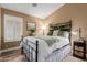 Charming bedroom with wood-look floors, bright window and a metal frame bed at 38560 N Joann Way, San Tan Valley, AZ 85140
