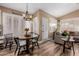 Cozy dining area with wooden floors and modern light fixtures and plantation shutters at 38560 N Joann Way, San Tan Valley, AZ 85140