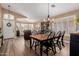 Open-concept dining room with abundant natural light, elegant wood flooring, and stylish furnishings at 38560 N Joann Way, San Tan Valley, AZ 85140