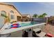 Inviting backyard with hot tub, seating area, and desert landscaping at 38560 N Joann Way, San Tan Valley, AZ 85140