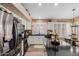 Bright kitchen featuring a center island with black countertop, stainless steel appliances and white cabinets at 38560 N Joann Way, San Tan Valley, AZ 85140