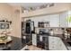 Modern kitchen with stainless steel appliances, granite countertops, and white cabinets offering ample storage space at 38560 N Joann Way, San Tan Valley, AZ 85140