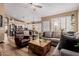 Spacious living area with wood flooring, natural light, and open floor plan to kitchen and dining area at 38560 N Joann Way, San Tan Valley, AZ 85140