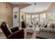 Cozy living room with wood floors, plantation shutters, and plenty of natural light at 38560 N Joann Way, San Tan Valley, AZ 85140
