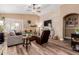 Bright living room featuring wood floors, a stone accent wall, and a comfortable seating arrangement at 38560 N Joann Way, San Tan Valley, AZ 85140