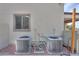 Exterior shot of the home's air conditioning units and a small, trimmed window at 40232 W Marion May Ln, Maricopa, AZ 85138