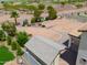 Aerial view of backyard featuring desert landscaping, mature trees, and privacy fence at 40232 W Marion May Ln, Maricopa, AZ 85138