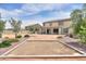 Spacious backyard with desert landscape, trees, patio, and view of neighboring houses at 40232 W Marion May Ln, Maricopa, AZ 85138