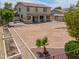 Aerial shot of an expansive backyard with desert landscaping and a covered patio at 40232 W Marion May Ln, Maricopa, AZ 85138