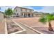 Large backyard featuring a patio, desert landscaping, garden, and covered outdoor kitchen at 40232 W Marion May Ln, Maricopa, AZ 85138
