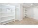 Bright bedroom closet featuring white shelves and rod, offering ample storage space at 40232 W Marion May Ln, Maricopa, AZ 85138