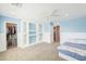 Bright bedroom with carpet, built-in shelves, a ceiling fan, and a closet at 40232 W Marion May Ln, Maricopa, AZ 85138