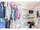 Walk-in closet with custom shelving and mirrored doors at 40232 W Marion May Ln, Maricopa, AZ 85138