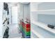Walk-in closet with custom shelving and mirrored doors at 40232 W Marion May Ln, Maricopa, AZ 85138