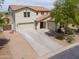 Stunning two-story home featuring a spacious driveway, three-car garage, and desert landscaping at 40232 W Marion May Ln, Maricopa, AZ 85138