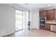 Well-lit kitchen with sliding glass doors to the patio and modern appliances at 40232 W Marion May Ln, Maricopa, AZ 85138