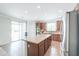 Modern kitchen with stainless steel appliances, an island, tile floors, and sliding glass doors at 40232 W Marion May Ln, Maricopa, AZ 85138
