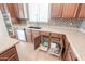 Kitchen features granite countertops, stainless steel appliances, undermounted sink, and convenient pull-out shelves at 40232 W Marion May Ln, Maricopa, AZ 85138