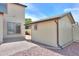 Exterior view of a shed with neutral siding and dark trim, adjacent to the main house at 40232 W Marion May Ln, Maricopa, AZ 85138
