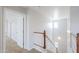 Bright stairway with white railing and natural light through large windows at 40232 W Marion May Ln, Maricopa, AZ 85138