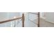 Bright staircase featuring white risers, and wooden banister with carpeting on the second floor at 40232 W Marion May Ln, Maricopa, AZ 85138