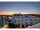 Sunset view of the city and skyline, featuring multiple story buildings, city lights, and mountain backdrop at 4422 N 75Th St # 8004, Scottsdale, AZ 85251