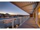 Condo balcony with pergola, glass railing, and city view at sunset with desert mountain backdrop at 4422 N 75Th St # 8004, Scottsdale, AZ 85251