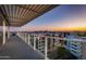 Enjoy breathtaking views from this balcony with modern railing and covered pergola; sunset enhances this outdoor space at 4422 N 75Th St # 8004, Scottsdale, AZ 85251