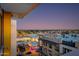 Enjoy beautiful city views from this high-rise balcony overlooking shops and lit streets, offering an urban oasis at 4422 N 75Th St # 8004, Scottsdale, AZ 85251