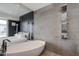 Spa-like bathroom featuring soaking tub, modern shower system, and bedroom views at 4422 N 75Th St # 8004, Scottsdale, AZ 85251