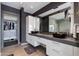 Modern bathroom with dual sinks, ample storage, and walk-in closet access at 4422 N 75Th St # 8004, Scottsdale, AZ 85251