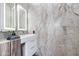 Modern bathroom featuring marble walls, sleek vanity, and illuminated mirror at 4422 N 75Th St # 8004, Scottsdale, AZ 85251