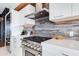 Close up of gourmet gas stove and range hood with luxury counter tops at 4422 N 75Th St # 8004, Scottsdale, AZ 85251