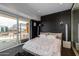 Bright bedroom boasting dark walls, plush carpeting, and private balcony with city views at 4422 N 75Th St # 8004, Scottsdale, AZ 85251