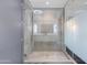 A modern open shower with sleek design, tiled walls, glass enclosure, and multiple shower heads at 4422 N 75Th St # 8004, Scottsdale, AZ 85251