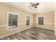 Bright bedroom featuring wood-look floors, tan walls, and a ceiling fan at 4516 W Fortune Dr, Phoenix, AZ 85086