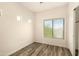 Bedroom featuring wood-look floors, a window, and white wall color at 4516 W Fortune Dr, Phoenix, AZ 85086